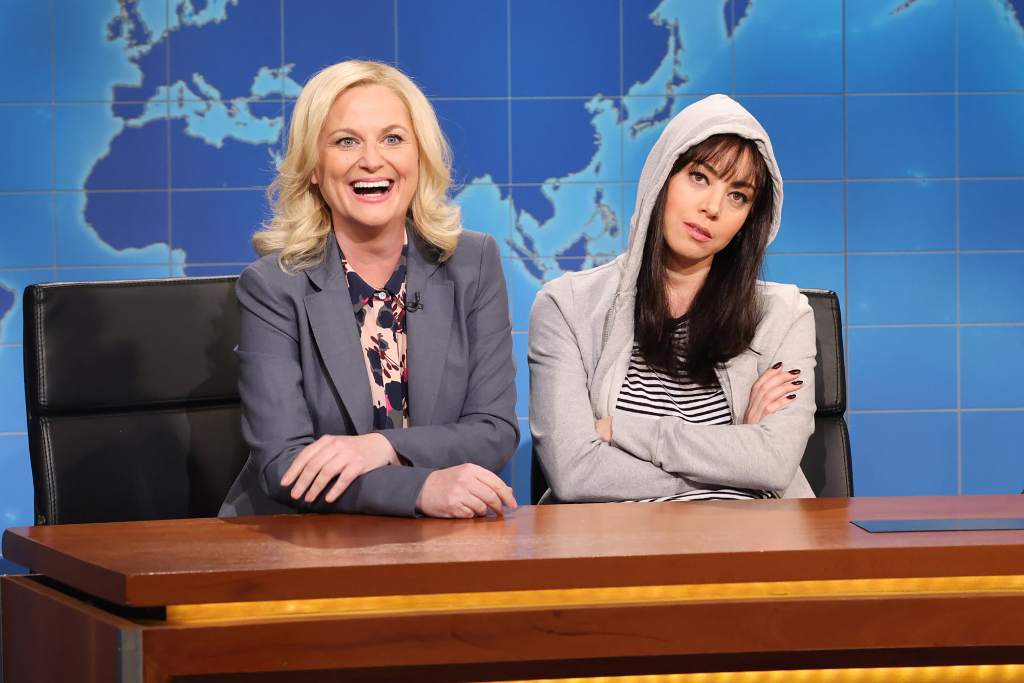 SATURDAY NIGHT LIVE -- Aubrey Plaza, Sam Smith Episode 1836 -- Pictured: (l-r) Amy Poehler as Leslie Knope, Host Aubrey Plaza as April Ludgate, and anchor Colin Jost during Weekend Update on Saturday, January 21, 2023 -- (Photo by: Will Heath/NBC via Getty Images)